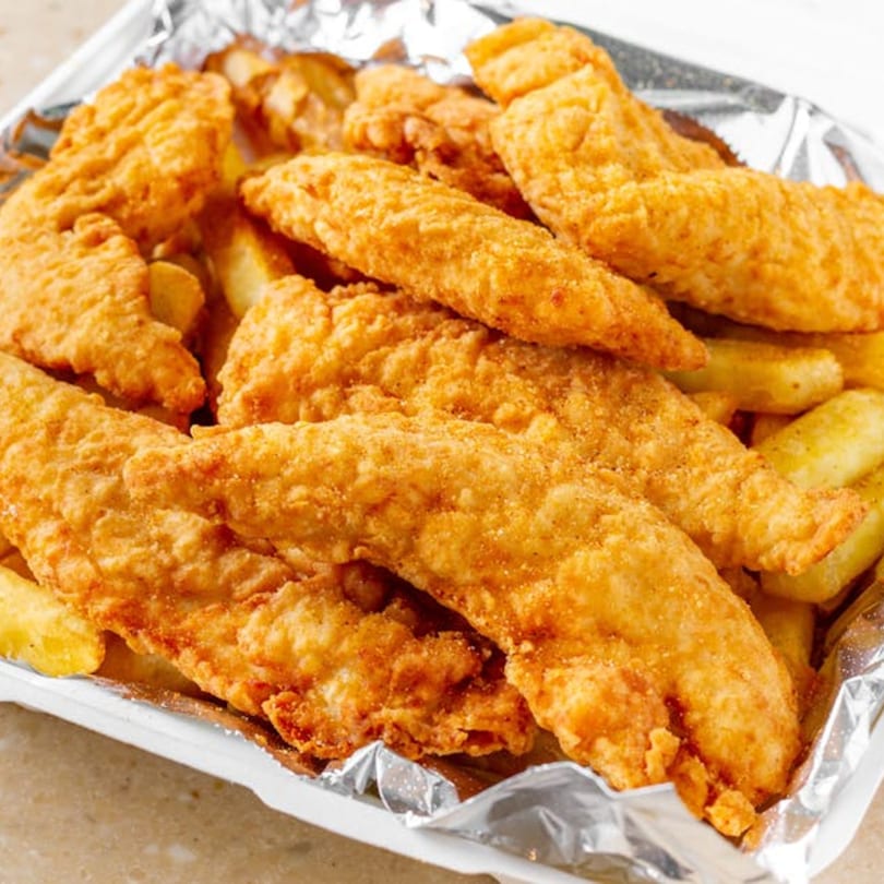 Golden-brown fried chicken strips and potato wedges in a foil-lined takeout container from Bellagio Wings & Pizza.